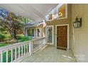 Inviting front porch with brick flooring, white railing, and natural lighting at 273 S Downs Way, Fort Mill, SC 29708