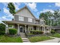 Beautiful two-story home with a covered front porch, complemented by lush landscaping and a well-manicured lawn at 2756 Von Thuringer Ct, Charlotte, NC 28210