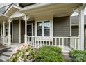 Inviting front porch with decorative white railing, complemented by colorful flowers and green shrubbery at 2756 Von Thuringer Ct, Charlotte, NC 28210