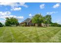 Landscaped brick home featuring a meticulously striped front lawn, mature trees, and classic architectural details at 3011 Patrick Place Cir, Clover, SC 29710