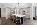 Stylish kitchen with a large center island, gray cabinetry, and stainless steel appliances at 4195 Island Fox Ln, Denver, NC 28037