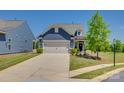 Charming blue home with a well-manicured front lawn and a two-car garage at 4502 Middlebury Ln, Fort Mill, SC 29715