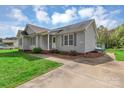 Charming home with gray siding, a covered porch, mature landscaping, and a concrete driveway at 4773 Westwinds Rd, Lincolnton, NC 28092