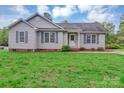 Charming one-story home features gray siding, black shutters, manicured lawn, and inviting curb appeal at 4773 Westwinds Rd, Lincolnton, NC 28092