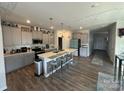 Modern kitchen features a large island with seating, stainless steel appliances, and ample cabinet space at 6499 Gopher Rd, Lancaster, SC 29720