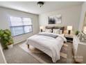 Cozy main bedroom with neutral tones, plush carpeting, and serene decor at 6525 Soapstone Dr, Charlotte, NC 28269