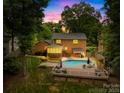 Beautiful backyard with pool, patio, deck and outdoor kitchen - perfect for entertaining at 6744 Wheeler Dr, Charlotte, NC 28211