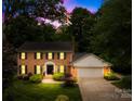 Charming brick two-story home with manicured lawn and welcoming entrance, complemented by lush landscaping at 6744 Wheeler Dr, Charlotte, NC 28211
