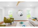 Bright living room featuring hardwood floors, a modern ceiling fan, and comfortable seating arrangement at 6744 Wheeler Dr, Charlotte, NC 28211