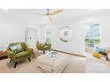 Bright living room featuring hardwood floors, a modern ceiling fan, and comfortable seating arrangement at 6744 Wheeler Dr, Charlotte, NC 28211