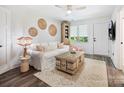 Cozy living room with neutral decor, ceiling fan, and natural light, creating a relaxing atmosphere at 7324 Swans Run Rd, Charlotte, NC 28226