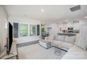 Spacious living room flows into the dining area, showcasing hardwood floors and stylish decor at 7518 Porrera St, Charlotte, NC 28214