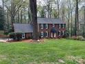 Beautifully landscaped two-story brick home with manicured lawn at 815 21St Avenue Nw Dr, Hickory, NC 28601