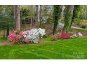 Beautifully landscaped yard with vibrant flowers and mature trees at 815 21St Avenue Nw Dr, Hickory, NC 28601