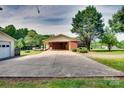 Spacious detached garage with a long driveway and ample parking space surrounded by lush greenery at 904 Sunbeam Dr, Lincolnton, NC 28092