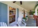 Inviting front porch featuring comfortable seating, ceiling fans, and decorative plants at 908 Gardenia St, Fort Mill, SC 29708