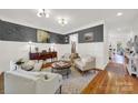 Bright living room with hardwood floors, wainscotting, designer paint, and stylish furnishings at 908 Gardenia St, Fort Mill, SC 29708