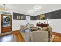 Cozy living room with hardwood floors, wainscotting, designer paint, and comfortable seating at 908 Gardenia St, Fort Mill, SC 29708