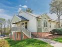 Inviting two-story home with a raised deck, brick foundation, and landscaped yard at 1022 Kenilworth Nw Ct, Concord, NC 28027