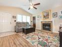Cozy living room with a stone fireplace, ceiling fan, and hardwood floors at 1022 Kenilworth Nw Ct, Concord, NC 28027