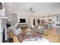 Open-concept living room showcasing a comfortable seating area, modern decor, and seamless flow to the kitchen at 107 Iris Meadow Dr, Mooresville, NC 28115