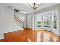 Bright foyer features gleaming hardwood floors, a staircase, and a charming bay window at 125 Snead Rd # 60, Fort Mill, SC 29715