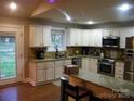 Well-equipped kitchen with stainless steel appliances, granite countertops, and ample cabinet space at 154 Tiger Oak Ln, Rockwell, NC 28138