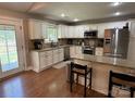 The kitchen features white cabinets, stainless steel appliances, and granite countertops at 154 Tiger Oak Ln, Rockwell, NC 28138