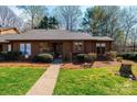 Charming single story home with brown siding, stone accents, manicured lawn and walkway to the front door at 1713 12Th Ne St, Hickory, NC 28601