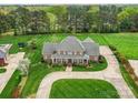 Expansive aerial view showing the home's well-manicured lawns, long driveway, and mature trees at 1902 Windmere Dr, Monroe, NC 28110