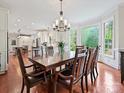 Bright dining room features a bay window, chandelier, and hardwood floors at 2313 Beechwood Dr, Waxhaw, NC 28173