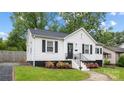 Cozy home with a white exterior, black shutters and landscaped flower beds around the front of the home at 2414 Remount Rd, Charlotte, NC 28208
