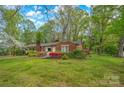 Attractive brick home with well-maintained lawn and colorful azalea bushes adding curb appeal at 252 Stamey Farm Rd, Statesville, NC 28677