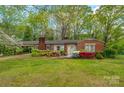 Quaint single story brick home with a carport and beautiful landscaping at 252 Stamey Farm Rd, Statesville, NC 28677