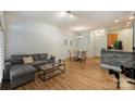 Open-concept living room features modern sofa, coffee table, and dining area at 2934 Selwyn Ave, Charlotte, NC 28209