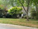 Well-maintained one-story home with a lush green lawn and mature trees at 3011 Lakewood Edge Dr, Charlotte, NC 28269