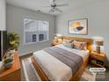 Cozy bedroom with natural light, neutral colors, ceiling fan and modern decor at 3114 Parker Green Trl, Charlotte, NC 28269