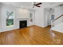 Bright living room with hardwood floors, fireplace, and large windows allowing ample natural light at 3114 Parker Green Trl, Charlotte, NC 28269