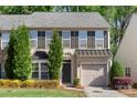 Well maintained exterior of home with shutters, manicured shrubbery, gray roof and an attached one car garage at 3214 Park South Station Blvd, Charlotte, NC 28210