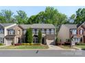 Charming two-story home with well-maintained landscaping, shutters, and an attached garage in a tree-lined neighborhood at 3214 Park South Station Blvd, Charlotte, NC 28210