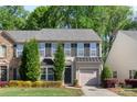 Charming two-story home with well-maintained landscaping, shutters, and an attached garage in a tree-lined neighborhood at 3214 Park South Station Blvd, Charlotte, NC 28210