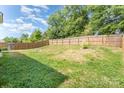 Spacious fenced backyard with mature trees, providing privacy and shade for outdoor activities at 3882 Shasta Cir, Clover, SC 29710