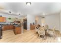 Open kitchen and dining area with wood floors, island, and ample cabinet space at 3882 Shasta Cir, Clover, SC 29710