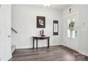 Inviting entryway features modern decor, wood-look floors, and a stylish table with decorative items, creating a warm welcome at 562 Amalfi Dr, Davidson, NC 28036