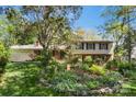 Charming two-story home with brick and siding exterior, surrounded by lush landscaping at 6921 Thermal Rd, Charlotte, NC 28211