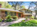 Traditional home with brick facade, lush landscaping, and an inviting brick walkway at 6921 Thermal Rd, Charlotte, NC 28211