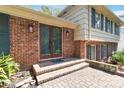 Close-up of a brick home's entrance featuring double doors and an inviting brick walkway at 6921 Thermal Rd, Charlotte, NC 28211