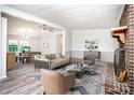 Inviting living room featuring neutral tones, a brick fireplace, and ample seating at 7050 Forney Hill Rd, Denver, NC 28037