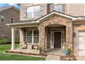 Inviting front porch with stone archway, stylish seating, and tasteful landscaping at 9069 Blue Ridge Dr, Indian Land, SC 29707
