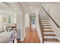 Elegant hallway features hardwood floors, staircase, and seamless transition to adjacent rooms at 9069 Blue Ridge Dr, Indian Land, SC 29707